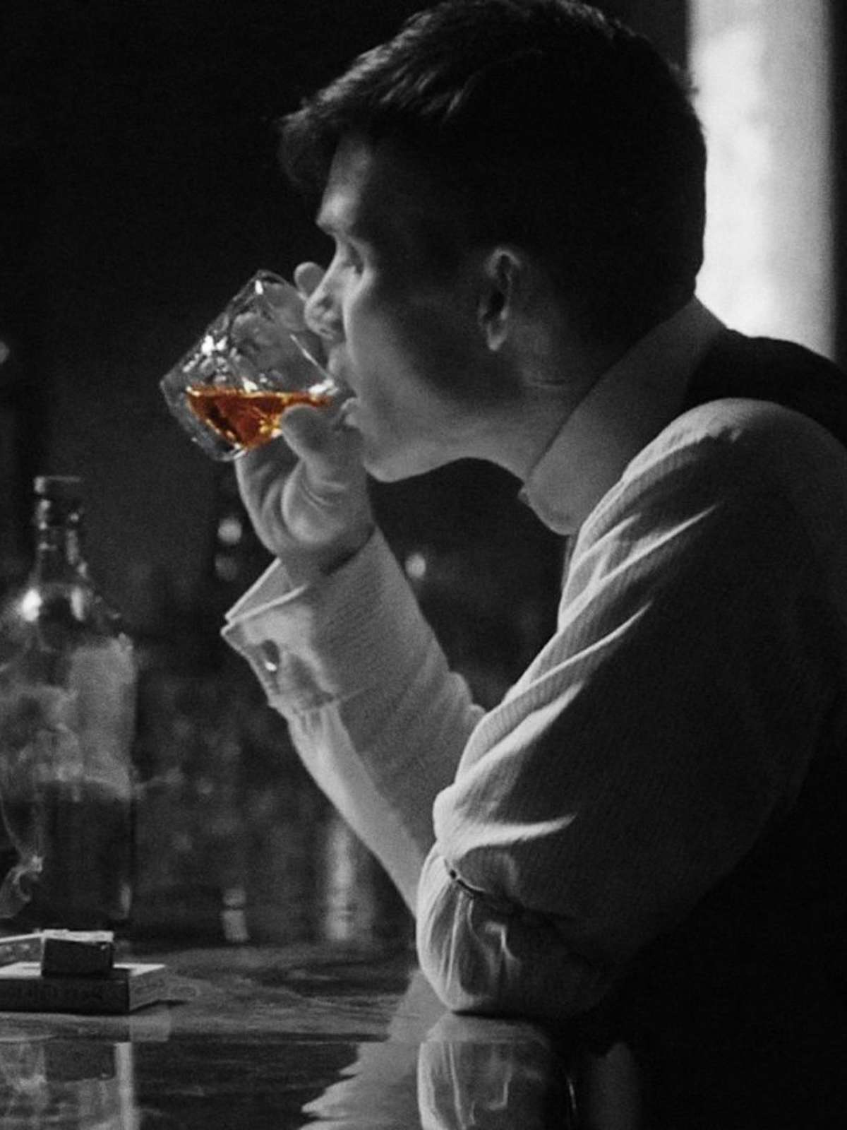 Man in tux at night with mist and lights - whiskey and cigar ritual, quiet elegance