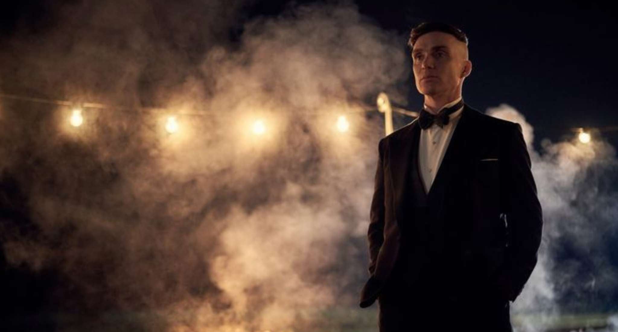 Man in tux at night with mist and lights - whiskey and cigar ritual, quiet elegance