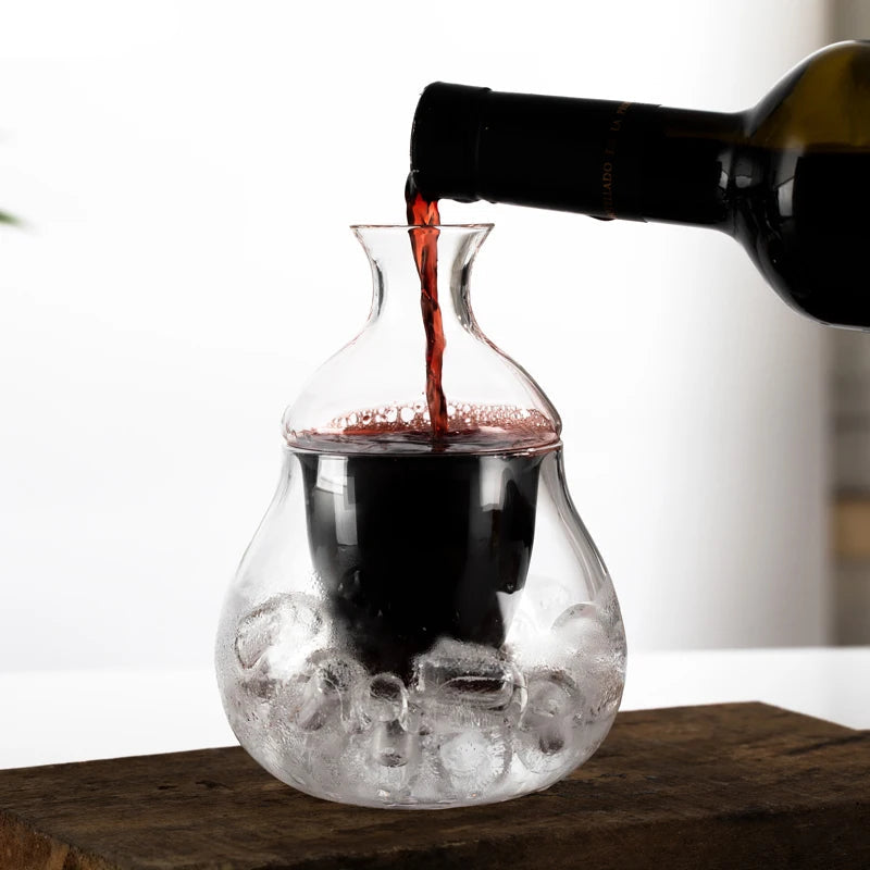wine decanter with ice base and glass tumbler on white bar surface
