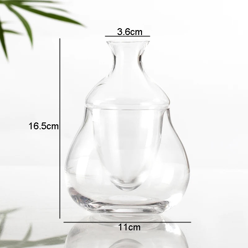 hand lifting inner chamber of whiskey from clear ice base glass decanter