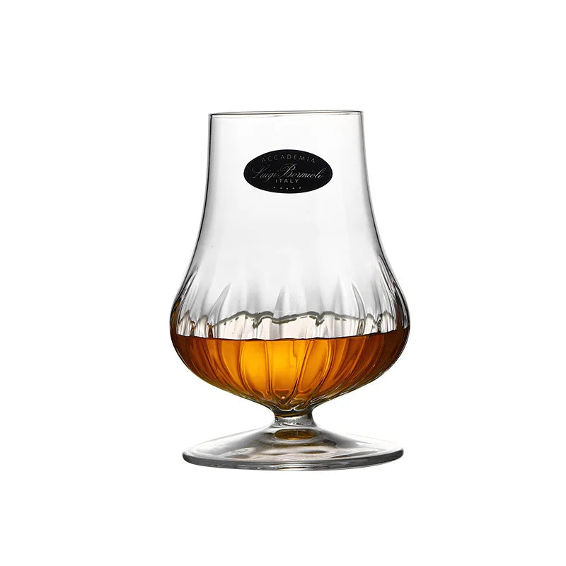 Two whiskey aroma glasses on marble table with golden scotch inside