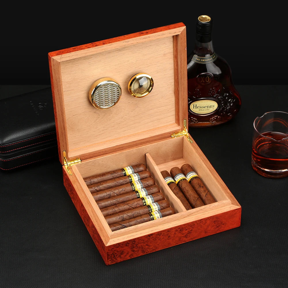 Open cedar travel humidor with hygrometer and humidifier, loaded with cigars on wooden table