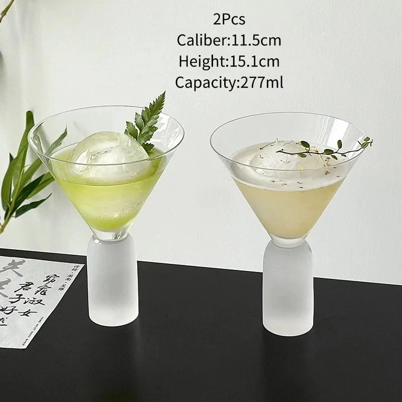 pair of frosted stem martini glasses filled with cocktails and round ice spheres