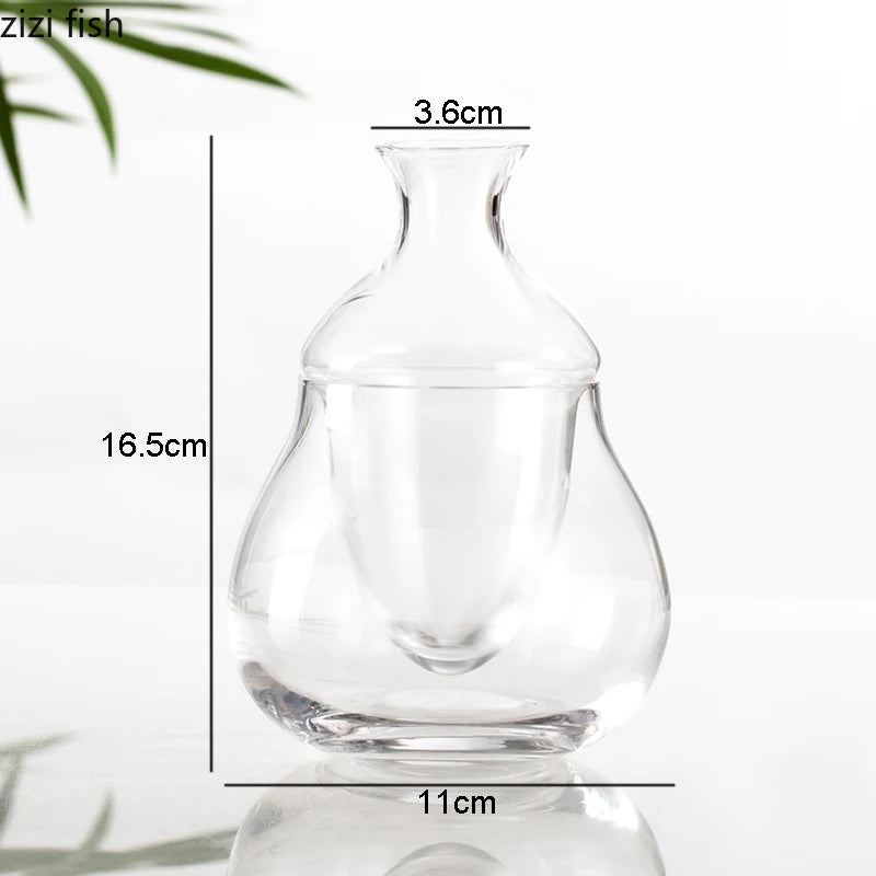 hand lifting inner chamber of whiskey from clear ice base glass decanter