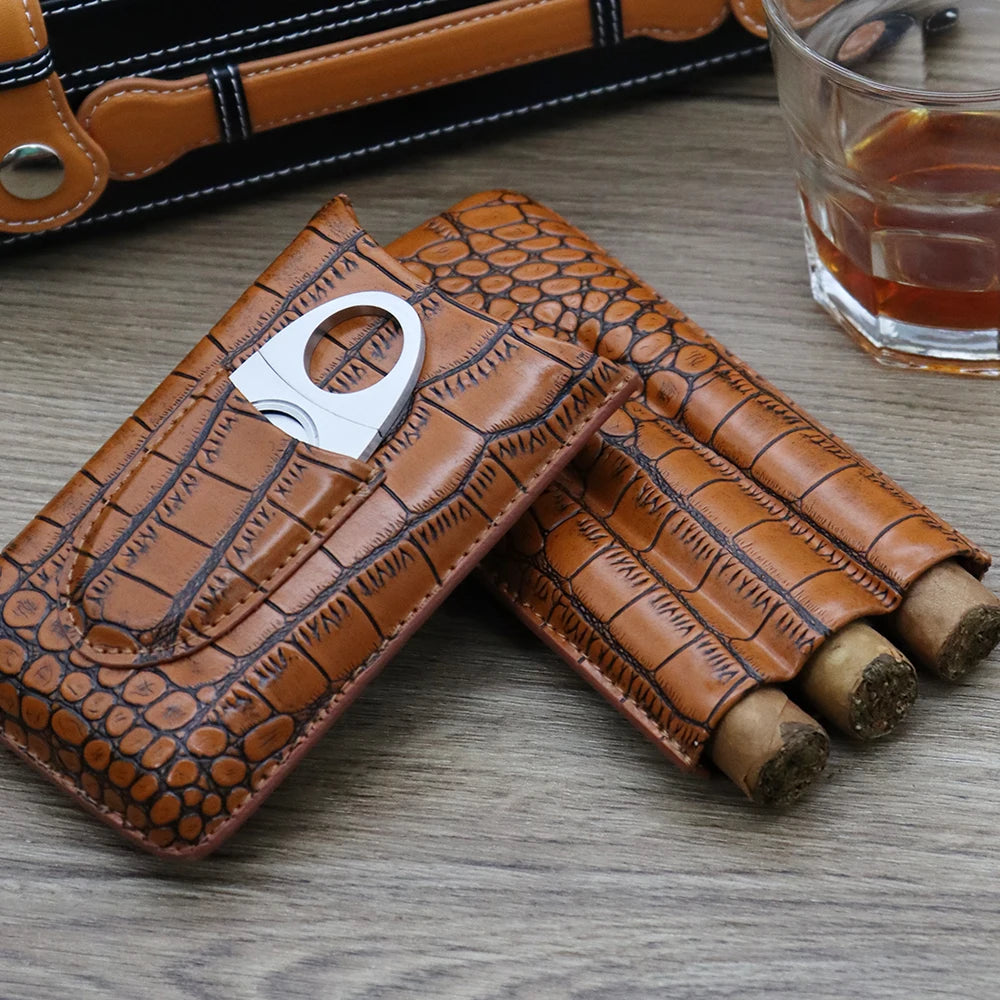 Leather 3-cigar travel case in black with front cutter pocket on wood surface