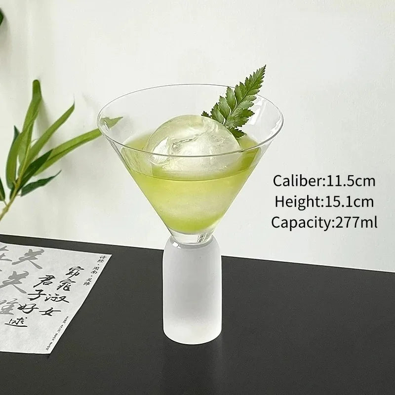 pair of frosted stem martini glasses filled with cocktails and round ice spheres