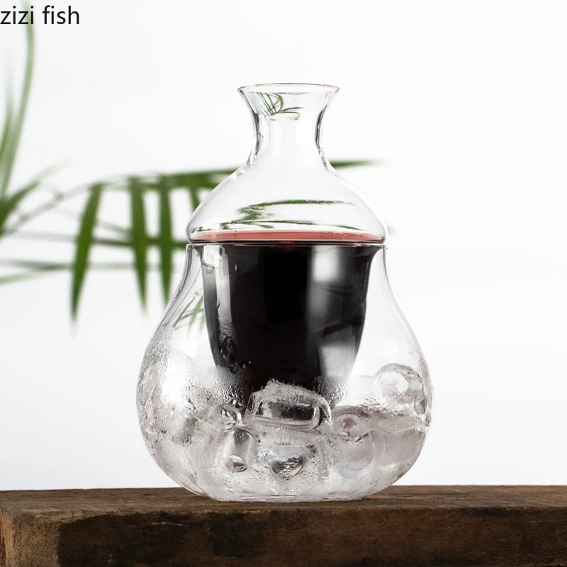 bottle pouring red wine into decanter with ice filled base on wooden board