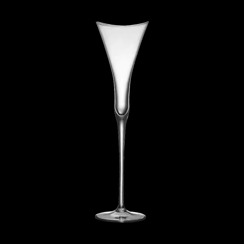 empty lead free crystal champagne glass standing on grey tabletop