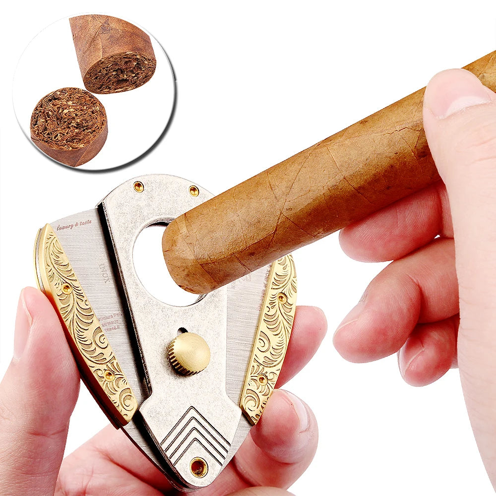 Gold-carved GALINER guillotine cigar cutter close-up on white background