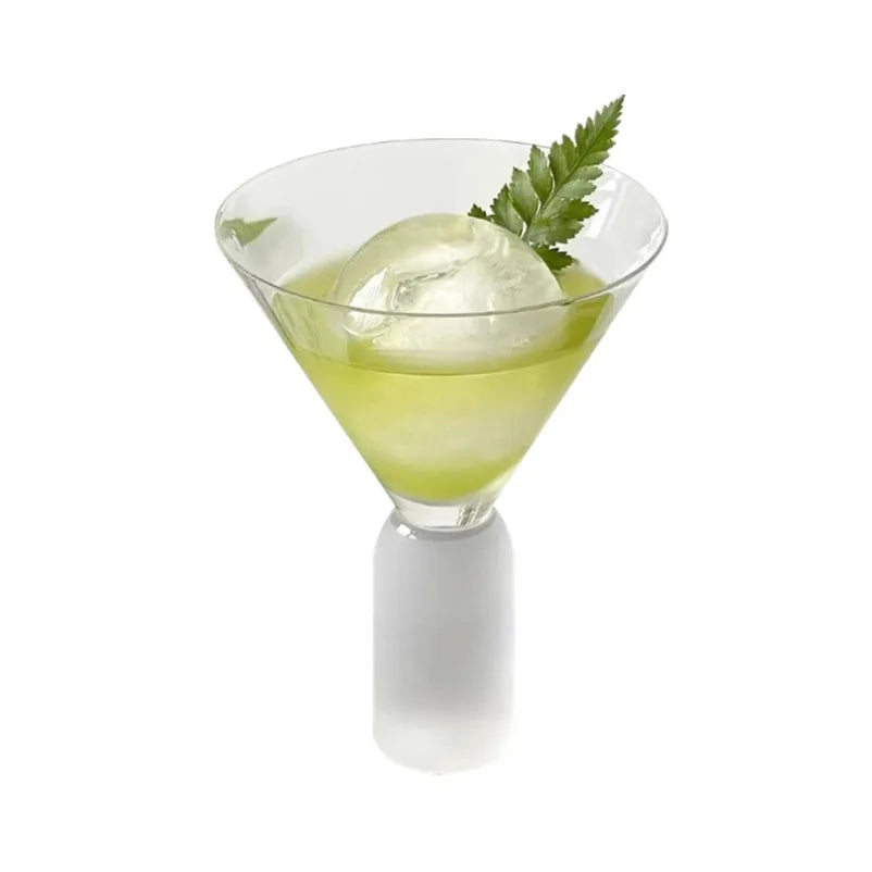 pair of frosted stem martini glasses filled with cocktails and round ice spheres