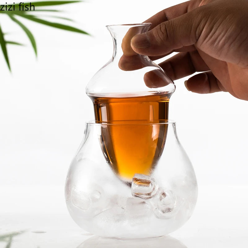 glass wine decanter showing inner chamber of red wine surrounded by ice