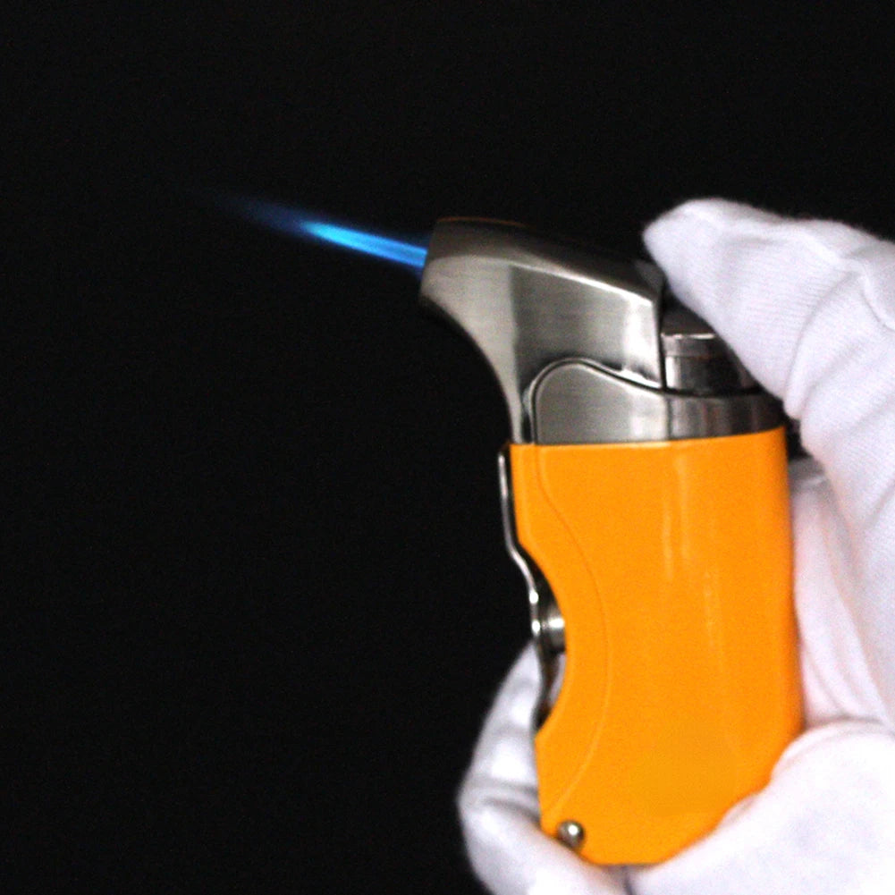 Stainless steel guillotine cigar cutter in hand — streamlined body and clean cut.