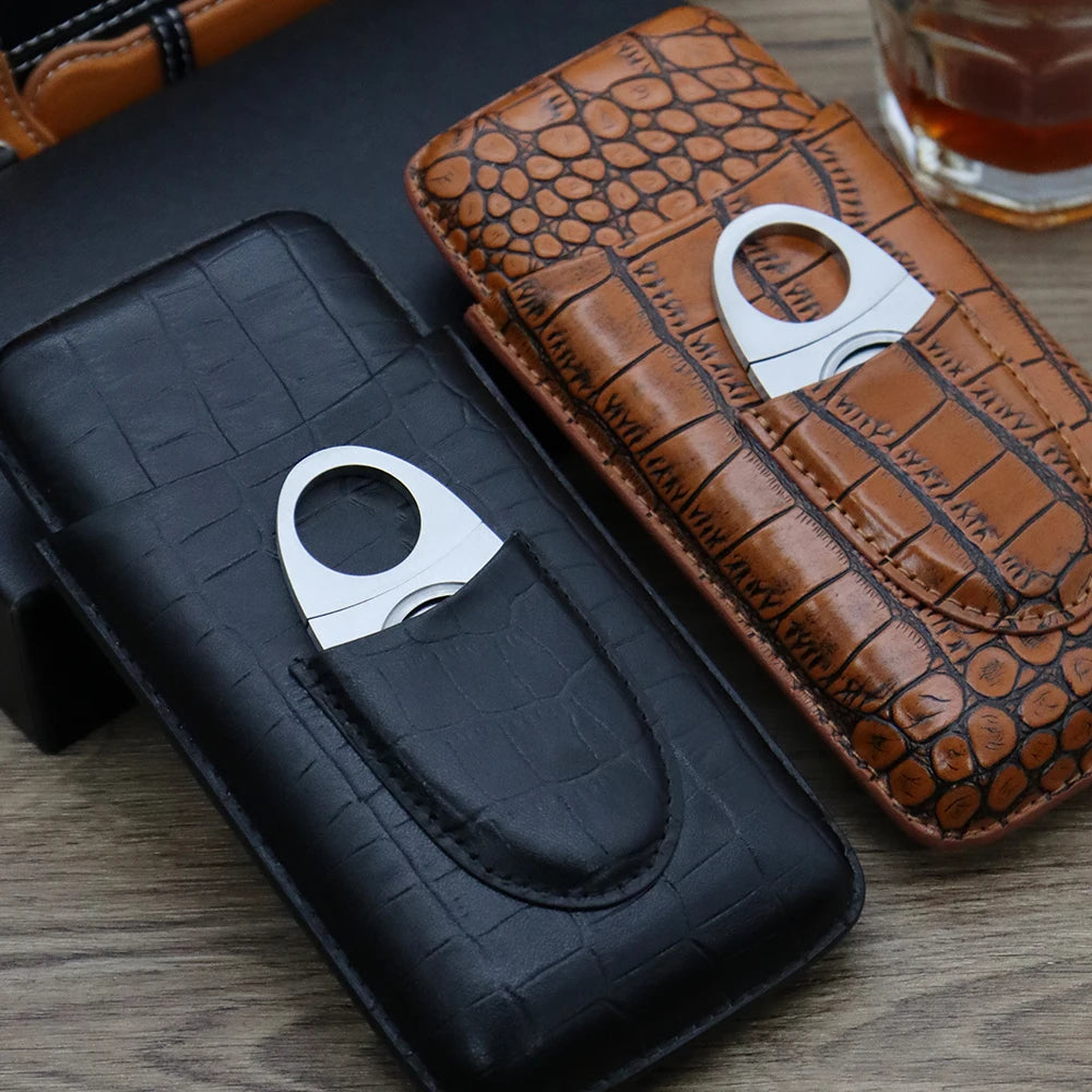 Brown crocodile-embossed leather cigar case with cutter pocket and suitcase in background