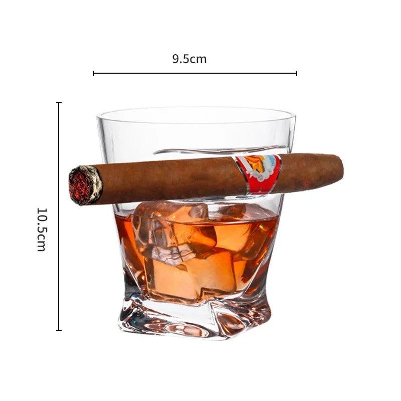 Hand holding whiskey and cigar glass during poker night