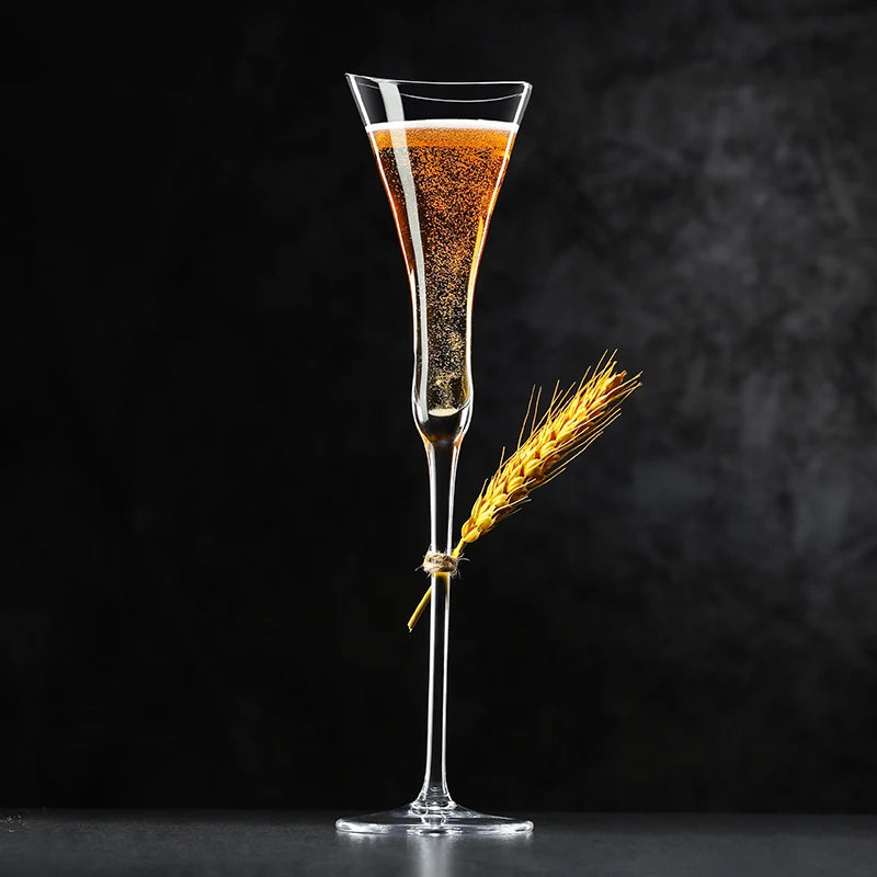 hand holding long stem crystal champagne glass during quiet toast